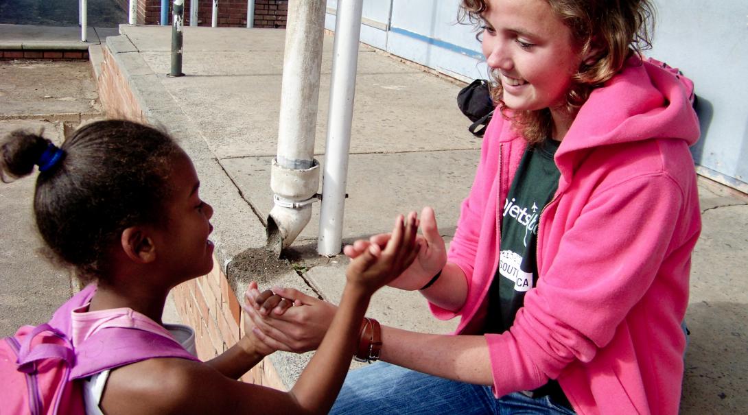 Projects Abroad volunteer works with a South Africa child during her gap year in 2019 Global Gap Year programme volunteer plays a game with a child during her project in South Africa